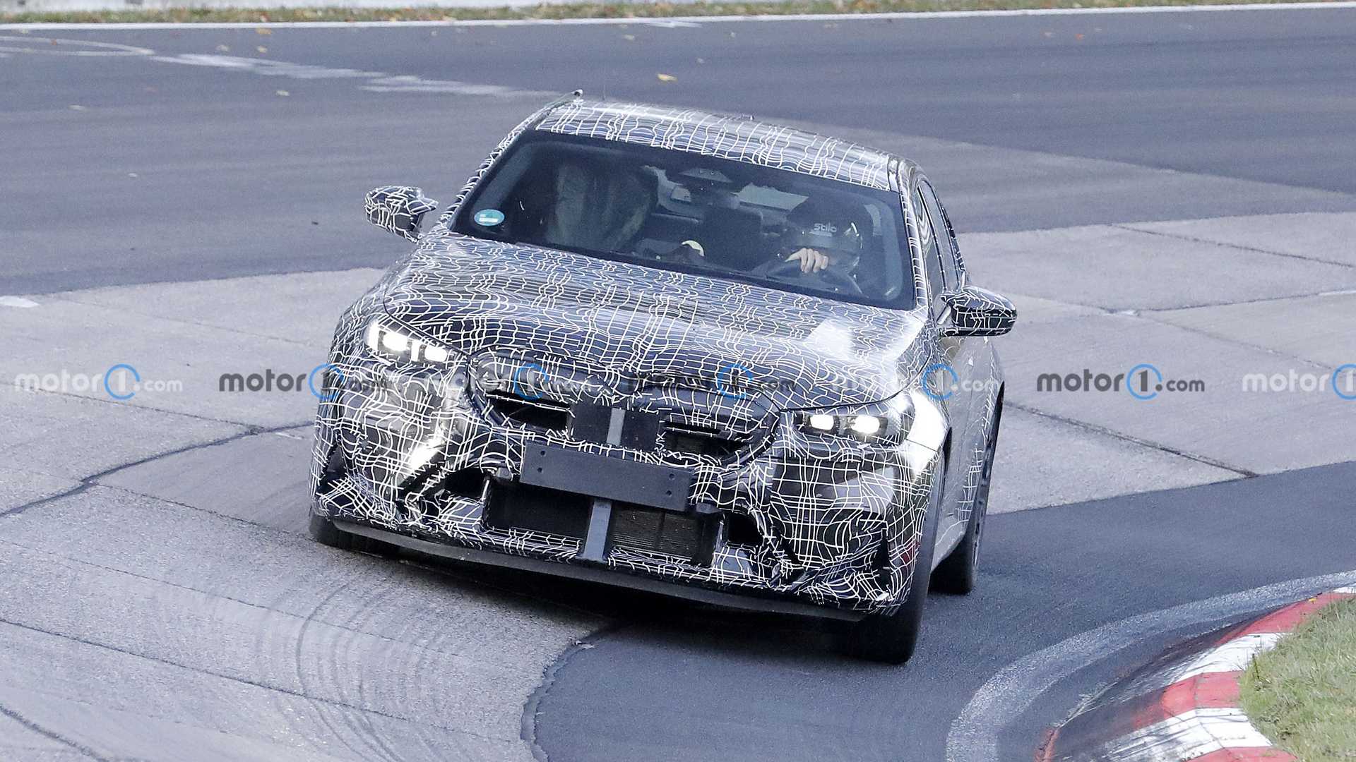 Spy footage captures 2024 BMW M5 interior with curved screen and flat