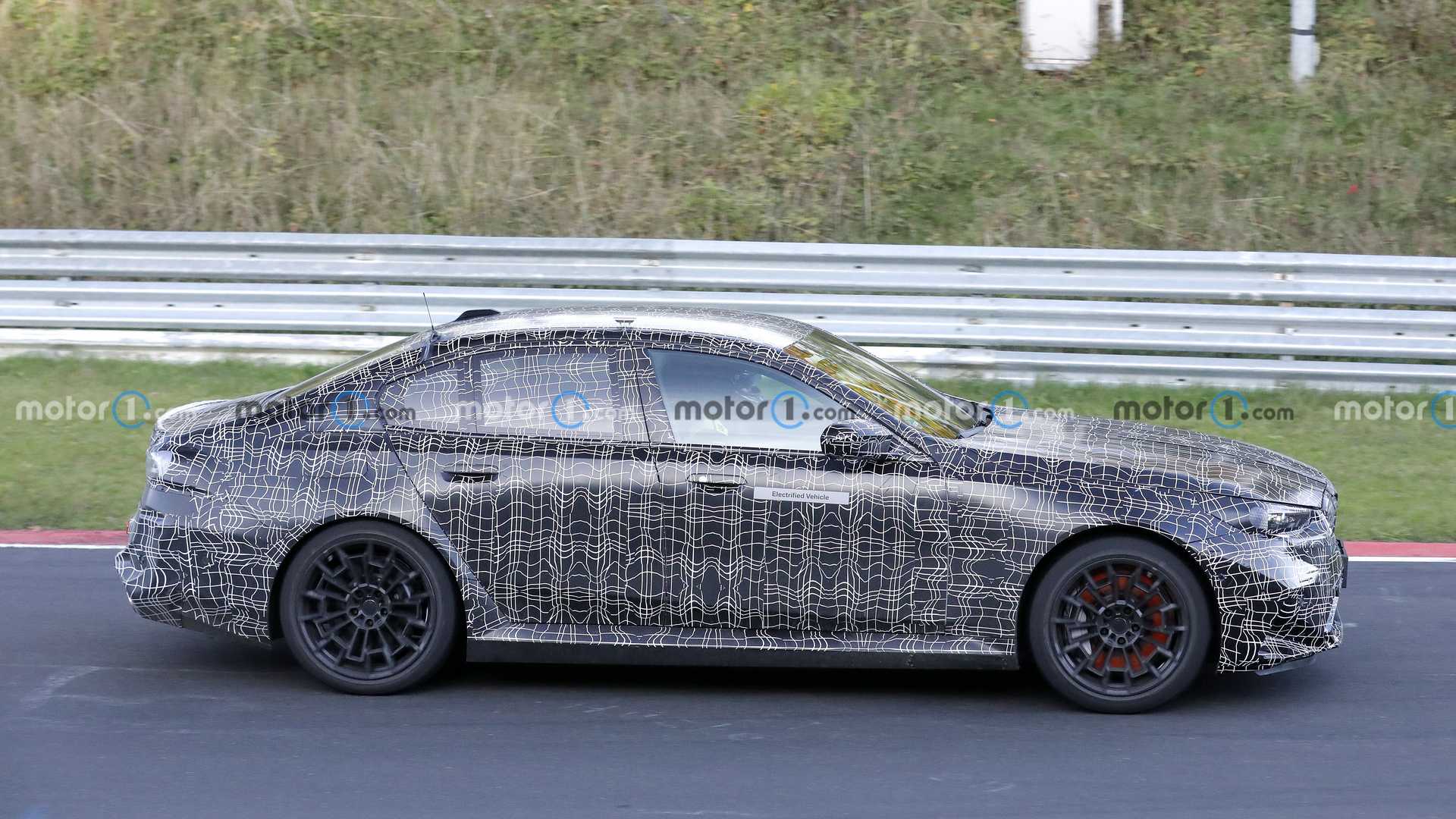 Spy footage captures 2024 BMW M5 interior with curved screen and flat