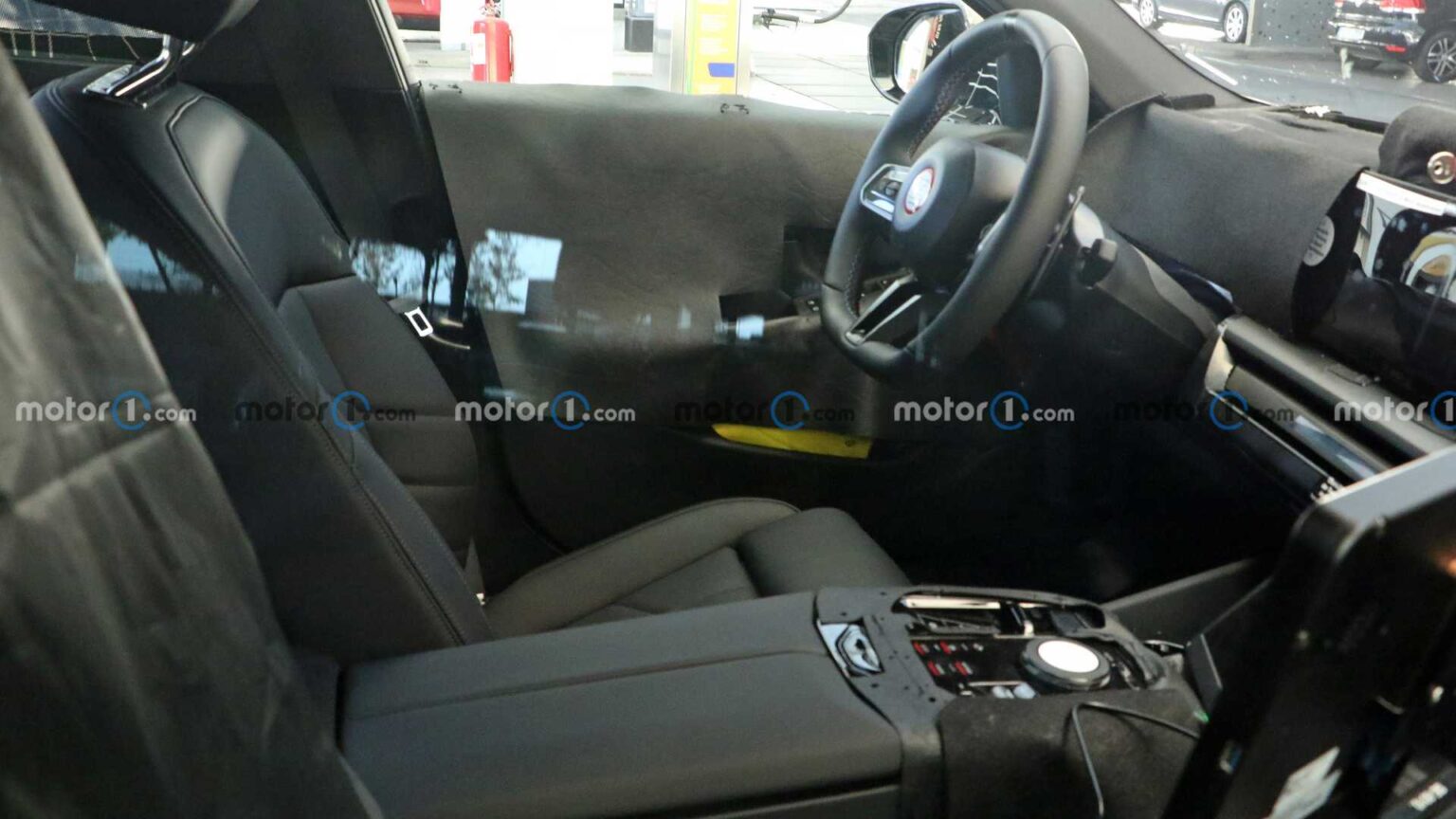 Spy footage captures 2024 BMW M5 interior with curved screen and flat