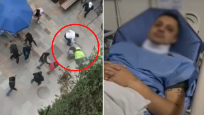 Policeman lying on a motorcycle in Colombia and beaten by indigenous people